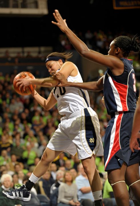 Notre Dame guard Ashley Barlow grabs a rebound away from Connecticut center Tina Charles.