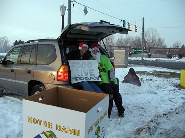 Senior Melissa D'Amico and assistant coach Angie (Potthoff) Barber were two of the many Irish women's basketball personalities stationed around campus during Thursday's 'Dish For The Holidays' food drive.
