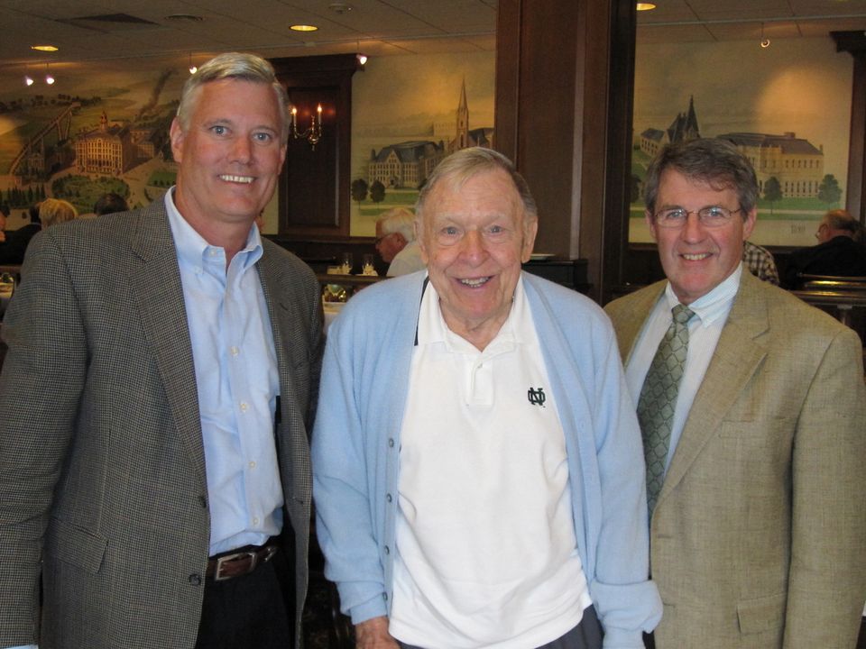 Former Irish swimmer Dan Rahill (left) and current Notre Dame swim coach Tim Welsh (right) informed Stark (center) of the honor at lunch on Sept. 30.