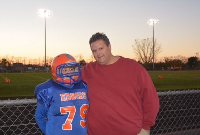 Jake, who is pictured with his father John, proudly wears his No. 79 uniform.  It is the same number worn by his friend, Steve Elmer.