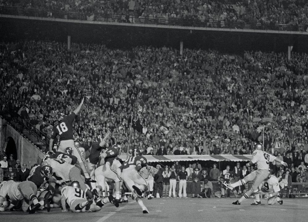 Bob Thomas (98) boots the game-winning field goal out of the hold of Brian Doherty.