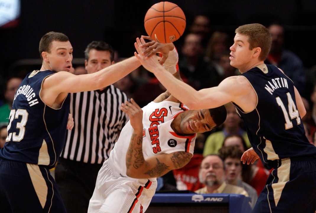 Ben Hansbrough tries blocking a pass from a St. John's player on Sunday afternoon.