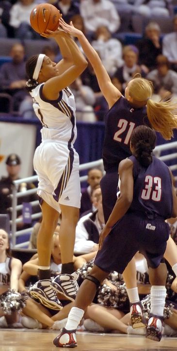 Jacqueline Batteast takes a jump shot as Connecticut's Nicole Wolff defends in the first half.