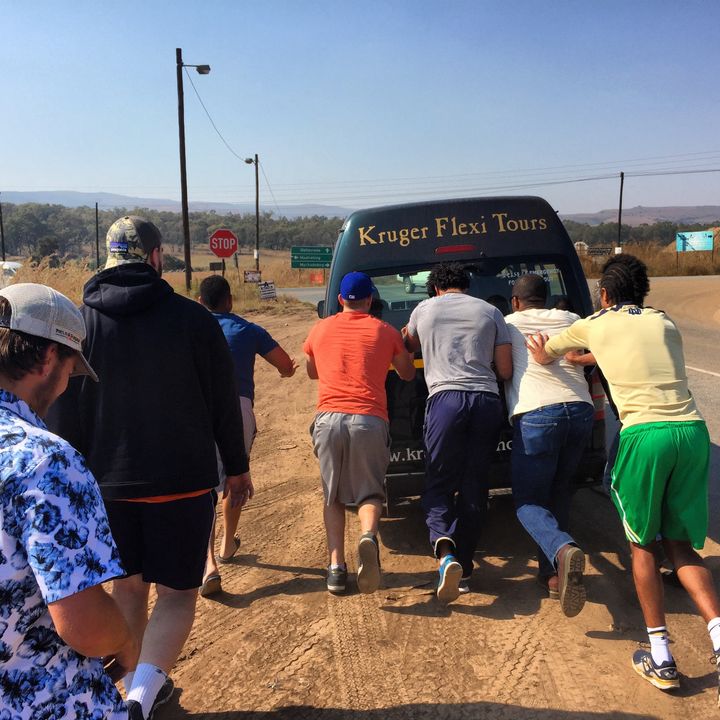 Corey Robinson and friends push a bus that broke down on the way to the safari.