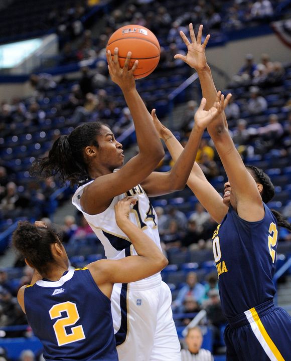Notre Dame's Devereaux Peters, center, shoots while being guarded by West Virginia's Taylor Palmer, left, and Asya Bussie.