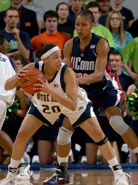 Notre Dame guard Ashley Barlow, left, gets ready to pass while Connecticut forward Maya Moore defends during the first half (AP Photo)