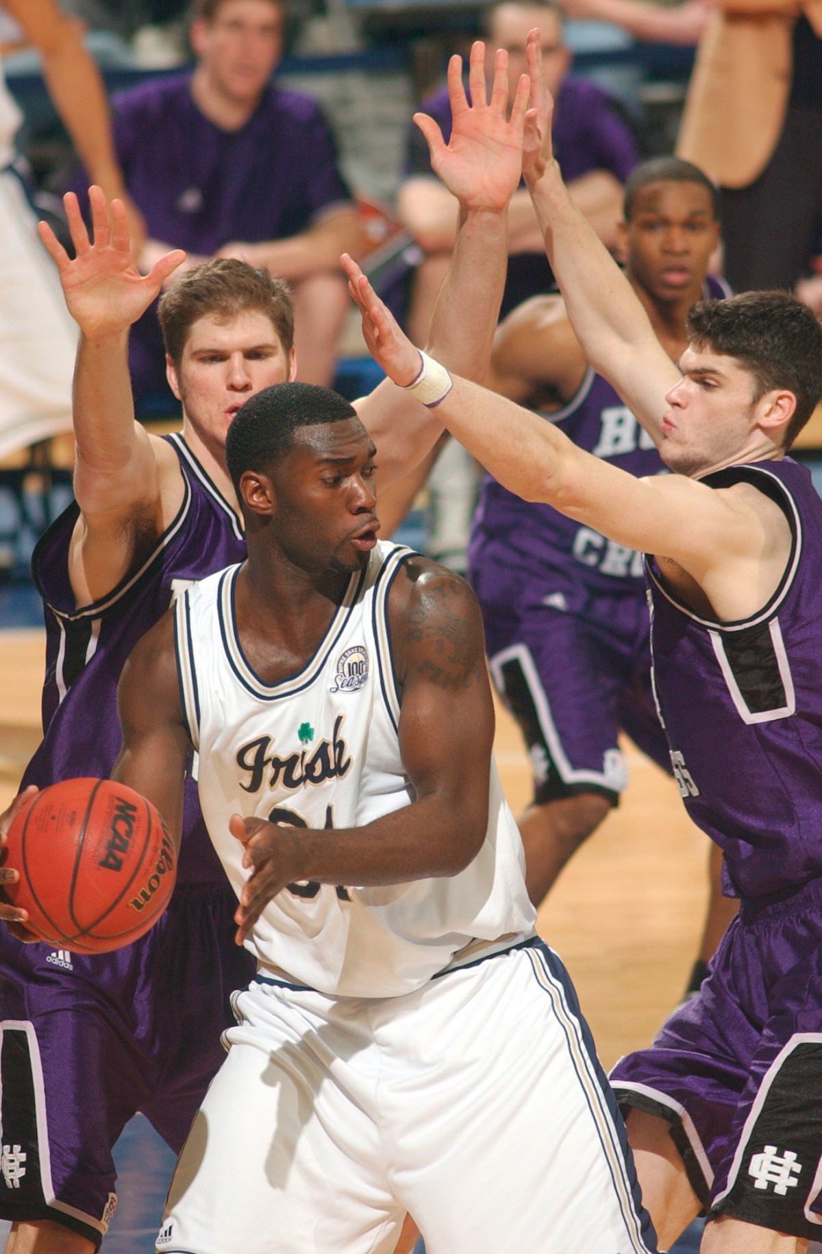 Notre Dame Falls To Holy Cross, 78-73 Torin Francis is surrounded by Holy Cross center Nate Lufkin, left, and forward John Hurley (24) during first-half action.