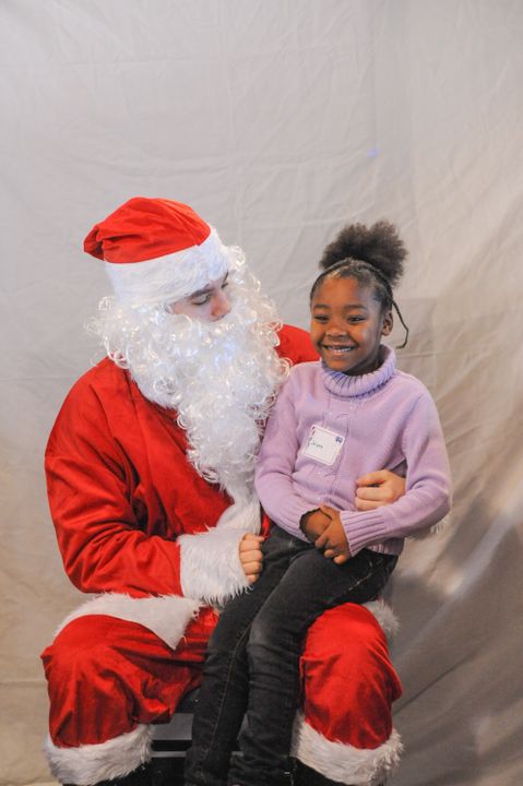Children visited with Santa Claus at the Athletics department's Adopt-A-Family celebration on December 14.