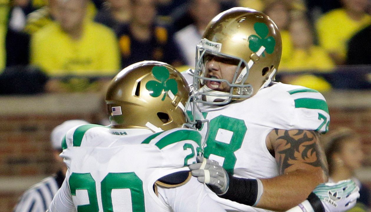 Notre Dame running back Cierre Wood is congratulated by teammate guard Trevor Robinson.