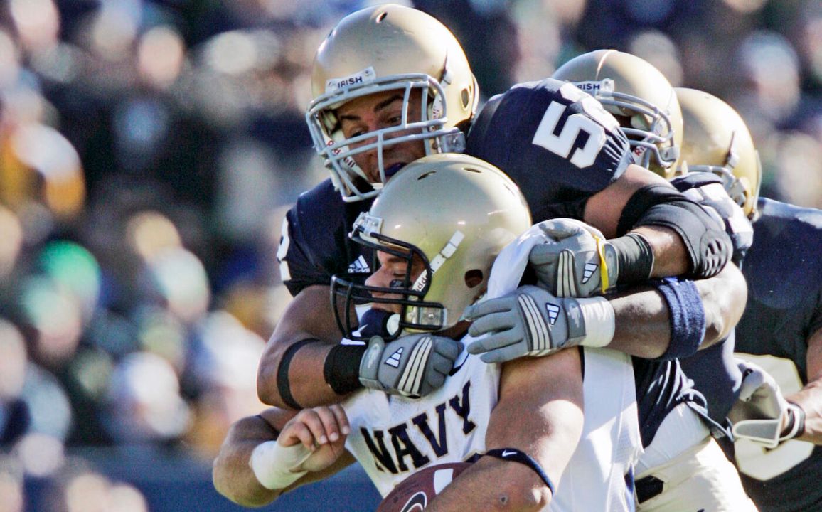 Navy running back Eric Kettani is stopped by  Joe Brockington in the first quarter. (AP Photo/Michael Conroy)
