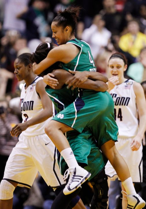 Skylar Diggins jumps into the arms of Devereaux Peters after Notre Dame's 72-63 win over Connecticut in the NCAA Women's Final Four national semifinals on April 3 at Conseco Fieldhouse in Indianapolis.