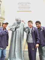 Stephen Bass Recaps Salzburg Sights In European Diary Santiago Montoya, Stephen Bass, and Sheeva Parbhu posing with a man posing as a statue in the streets of Salzburg.