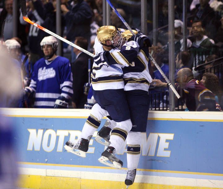 Kyle Lawson and Ryan Thang celebrate Thang's overtime game winner that sends Notre Dame on to the Midwest Regional finals.