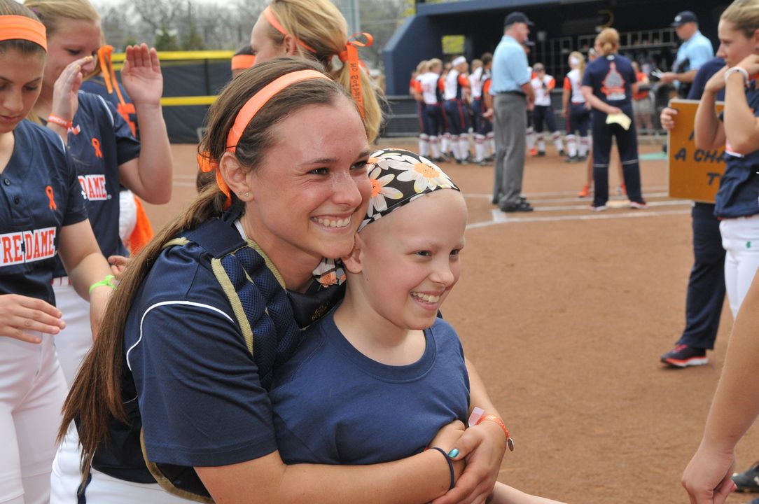 Senior catcher Casey Africano and softball Fighting Irish Fight for Life teammate Hannah at the 2015 Strikeout Cancer series