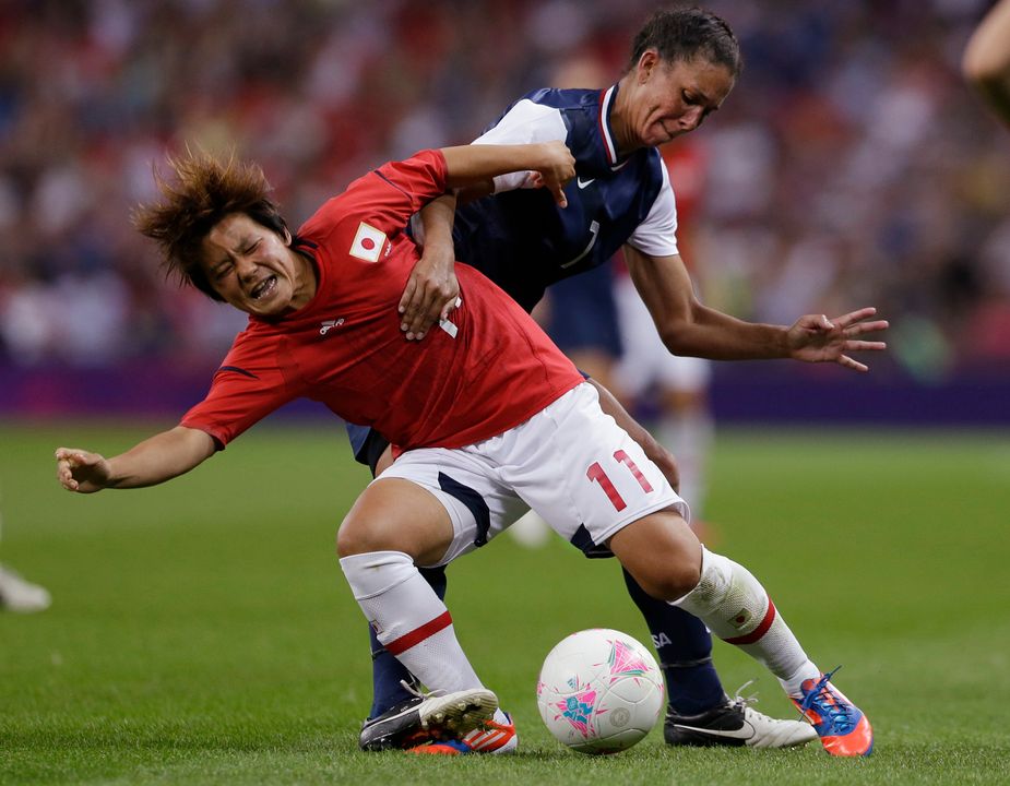 Shannon Boxx (right) became the first Notre Dame athlete to earn three Olympic gold medals when she helped lead the United States to a 2-1 victory over Japan in the women's soccer gold medal match in London's Wembley Stadium before a record crowd of 80,203. (Photo courtesy of Associated Press)