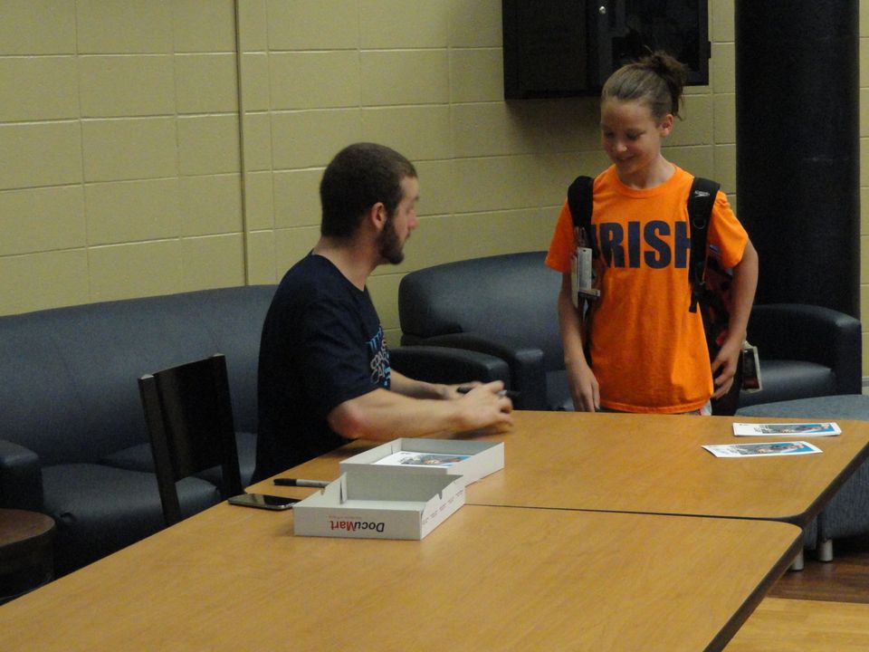 Olympic gold medalist Tyler Clary signed autographs for young swimmers before Saturday's clinic.