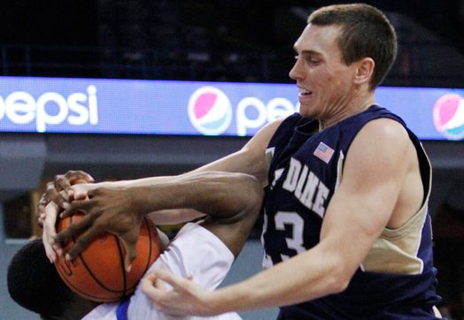 Ben Hansbrough, right, battles for a rebound with Saint Louis' Cory Remekun during the first half. (AP Photo/Nam Y. Huh)