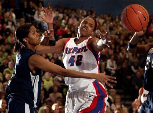 DePaul's Khara Smith (42) reaches for a loose ball under the basket as Notre Dame's Charel Allen, left, defends during the first half of an NCAA basketball game Sunday, Feb. 12, 2006 in Chicago. (AP Photo/Jeff Roberson)