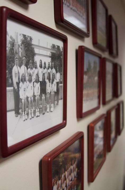 These framed photos of past Notre Dame volleyball teams on the wall of head coach Debbie Brown's office help reinforce the importance of family to the Fighting Irish coach and her program.