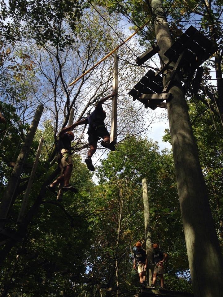 With Bonfires Comes Team Bonding members of the Notre Dame men's swim team tackled a high ropes course during a pre-season trip to Pretty Lake campsite in Mattawan, Michigan.