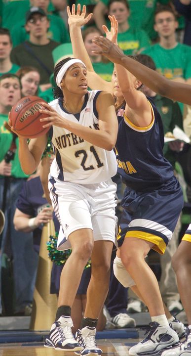 Jacqueline Batteast attempts to throw a pass around West Virginia guard Meg Bulger during first half action.