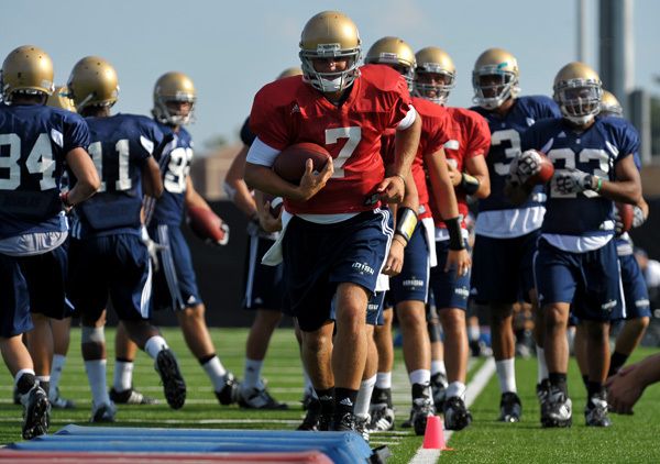 Jimmy Clausen leads the WRs and QBs through warm up drills at Notre Dame football practice.
